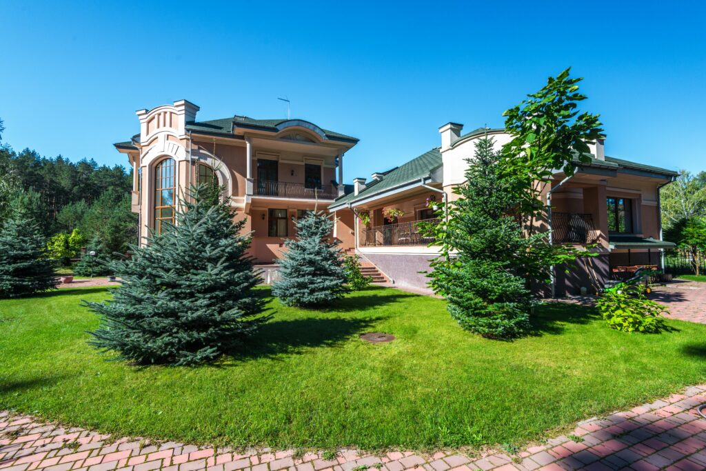 Elegant suburban estate with modern architecture amidst lush greenery, captured on a sunny day.